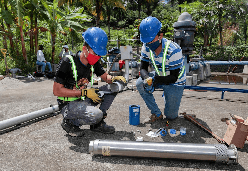 two men working on water pipes